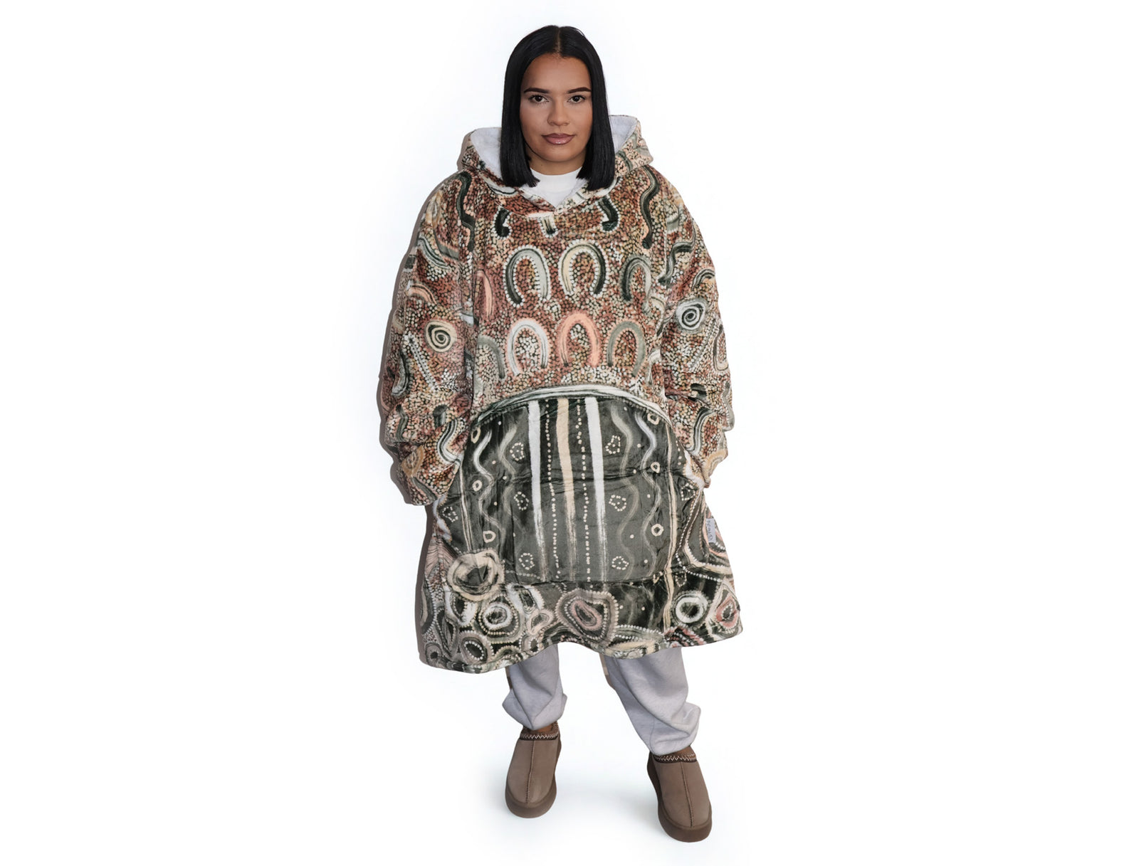 Neutral-toned oversized wearable blanket hoodie with Aboriginal-inspired pattern and front kangaroo pocket