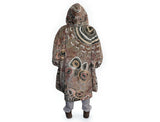 Neutral-toned oversized wearable blanket hoodie with Aboriginal-inspired pattern and front kangaroo pocket