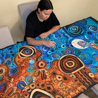 Aboriginal artist Kelly Taylor painting Desert Meets the Sea artwork in her South Australian studio
