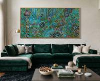 Living room with a green velvet sofa, coffee table, and colorful Luxury Indigenous Australian wall art painting on the wall.