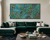 Living room with a green velvet sofa, coffee table, and abstract painting on the wall.