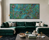 Living room with a green velvet sofa, coffee table, and abstract painting on the wall.