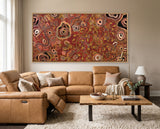 Out on Country Aboriginal art print by Kelly Taylor displayed in a contemporary living room featuring traditional waterholes, journey lines and family connections across Country