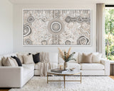 Large Camping Under the Moonlight Aboriginal canvas print displayed above a modern white sofa.