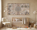 Modern living room with a aboriginal art painting camping under the moonlight above cot with wooden sofa, coffee table, and abstract wall art.