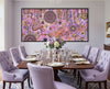 Family Day Out original Aboriginal painting by Kelly Taylor displayed above a luxury dining room table with soft purple chairs.