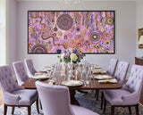 Family Day Out original Aboriginal painting by Kelly Taylor displayed above a luxury dining room table with soft purple chairs.