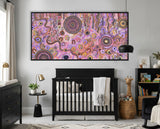 Family Day Out Aboriginal artwork displayed in a contemporary nursery with black cot and natural decor.