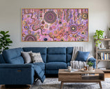 Family Day Out original Aboriginal painting by Kelly Taylor displayed above a blue lounge in a modern living room.