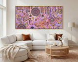 Family Day Out Aboriginal artwork displayed above a cream sofa in a bright luxury living room.