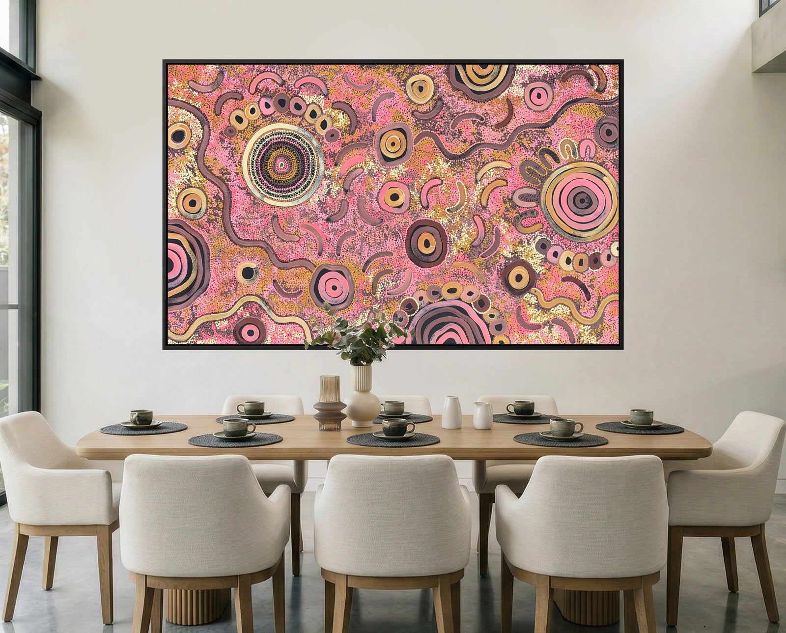 Dining room with a large aboriginal art abstract pink and black painting on the wall.