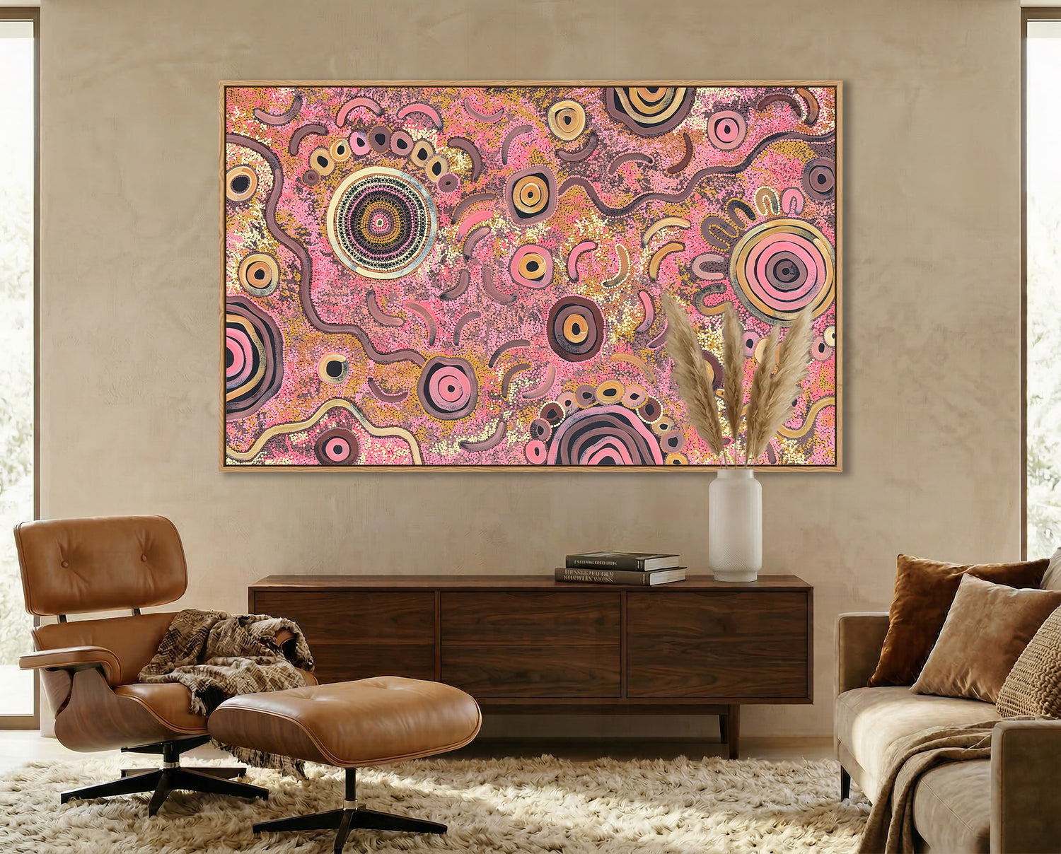 Colorful aboriginal art abstract painting on a wall above a wooden console table in a living room.