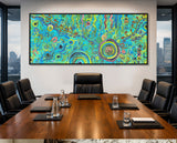 Boardroom with a large abstract aboriginal art painting on the wall, wooden table, and chairs.