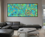 Living room with a large abstract aboriginal art painting on the wall above a gray sectional sofa.