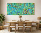 Dining room with a colorful abstract aboriginal art painting on the wall above a wooden table and chairs.
