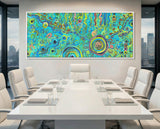 Colorful abstract aboriginal art painting in a modern office setting with a conference table and chairs.