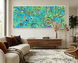 Living room with a colorful abstract aboriginal art painting on the wall, a sofa with pillows, and a wooden cabinet.