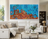 Desert Meets the Sea original Aboriginal artwork creating a feature wall in a contemporary white living room.