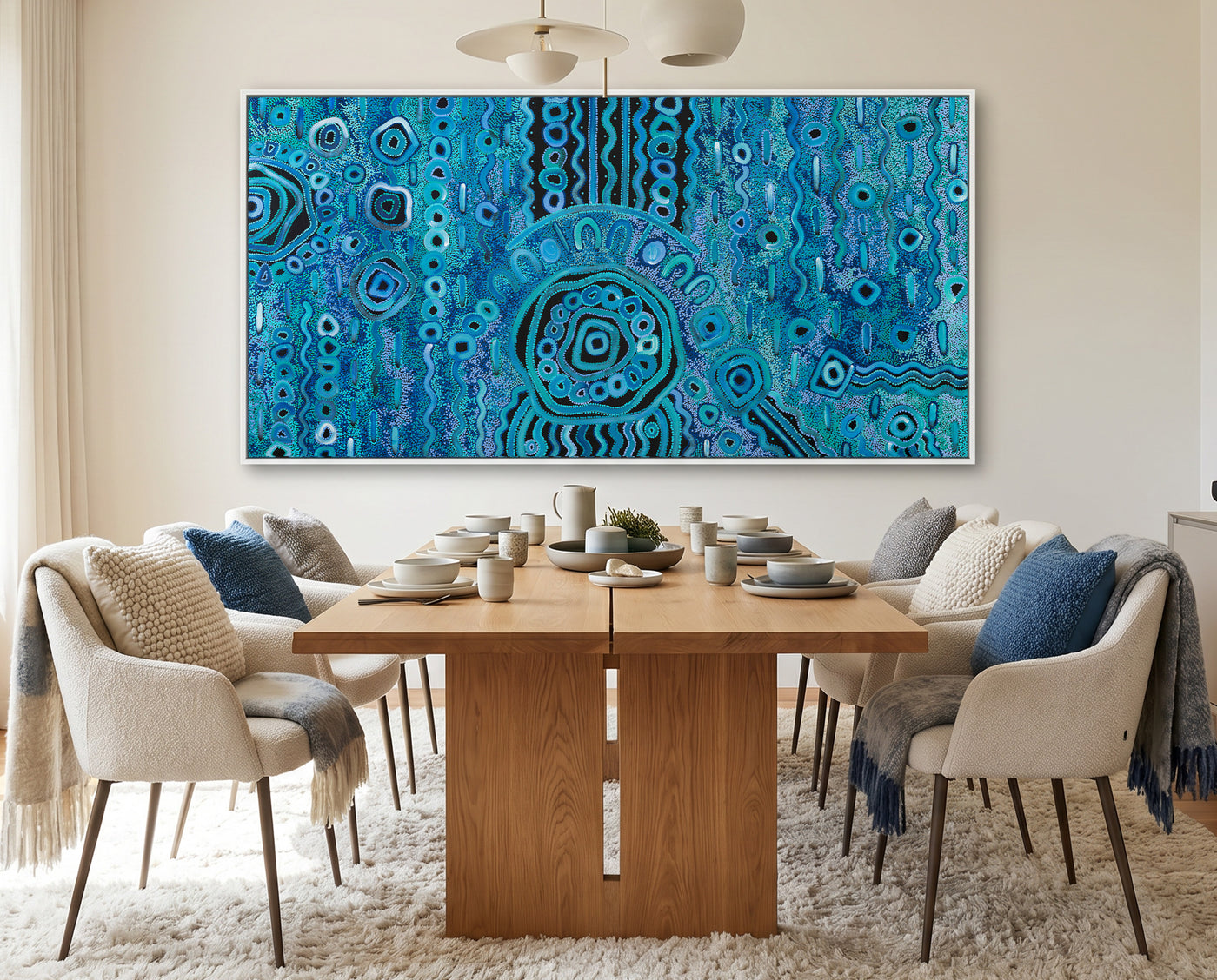Dining room with a wooden table and chairs, and a large blue rain aboriginal art abstract painting on the wall.