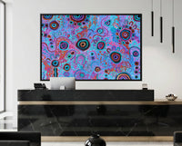 Modern reception area with a colorful aboriginal art painting by T'keyah Ware painting on a wall.