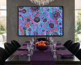 Large colourful Aboriginal artwork by T'keyah Ware creating a statement feature wall in a luxury black dining room with purple tableware.