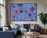 Original Aboriginal artwork My Mother's Country by T'keyah Ware displayed above a blue sofa in a modern luxury living room.