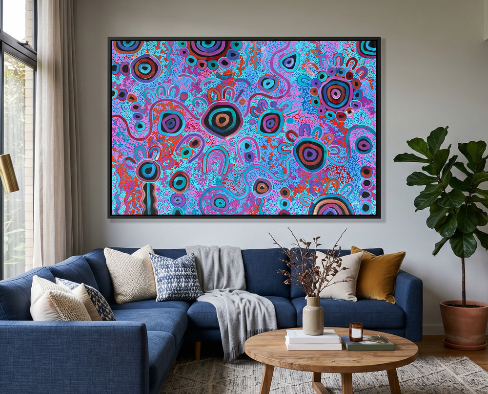 Original Aboriginal artwork My Mother's Country by T'keyah Ware displayed above a blue sofa in a modern luxury living room.