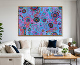 Colorful abstract art piece on a wall above a white sofa in a living room.