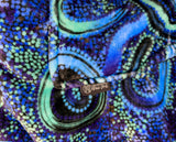 Woman wearing oversized blue rain Aboriginal art hooded blanket with sherpa lining and front pocket