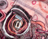 Woman wearing pink oversized hooded blanket with Indigenous aboriginal  inspired artwork and plush fleece lining