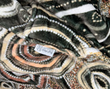 Neutral-toned oversized wearable blanket hoodie with Aboriginal-inspired pattern and front kangaroo pocket
