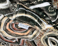 Neutral-toned oversized wearable blanket hoodie with Aboriginal-inspired pattern and front kangaroo pocket