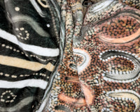 Neutral-toned oversized wearable blanket hoodie with Aboriginal-inspired pattern and front kangaroo pocket